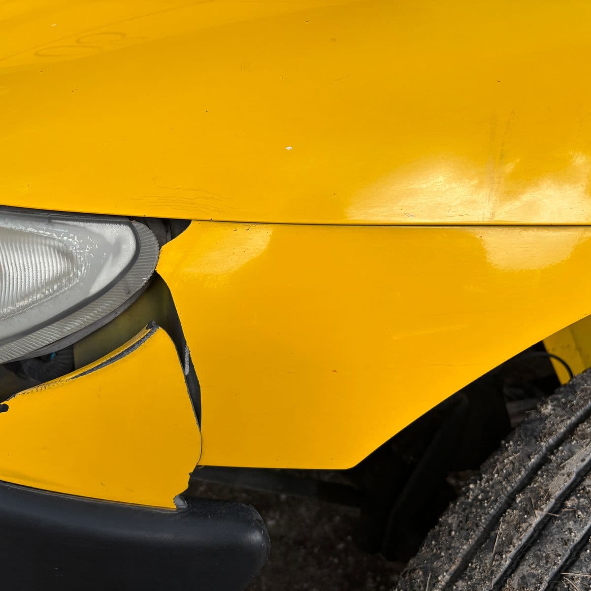 Damaged front bumper assessed for repair or replacement