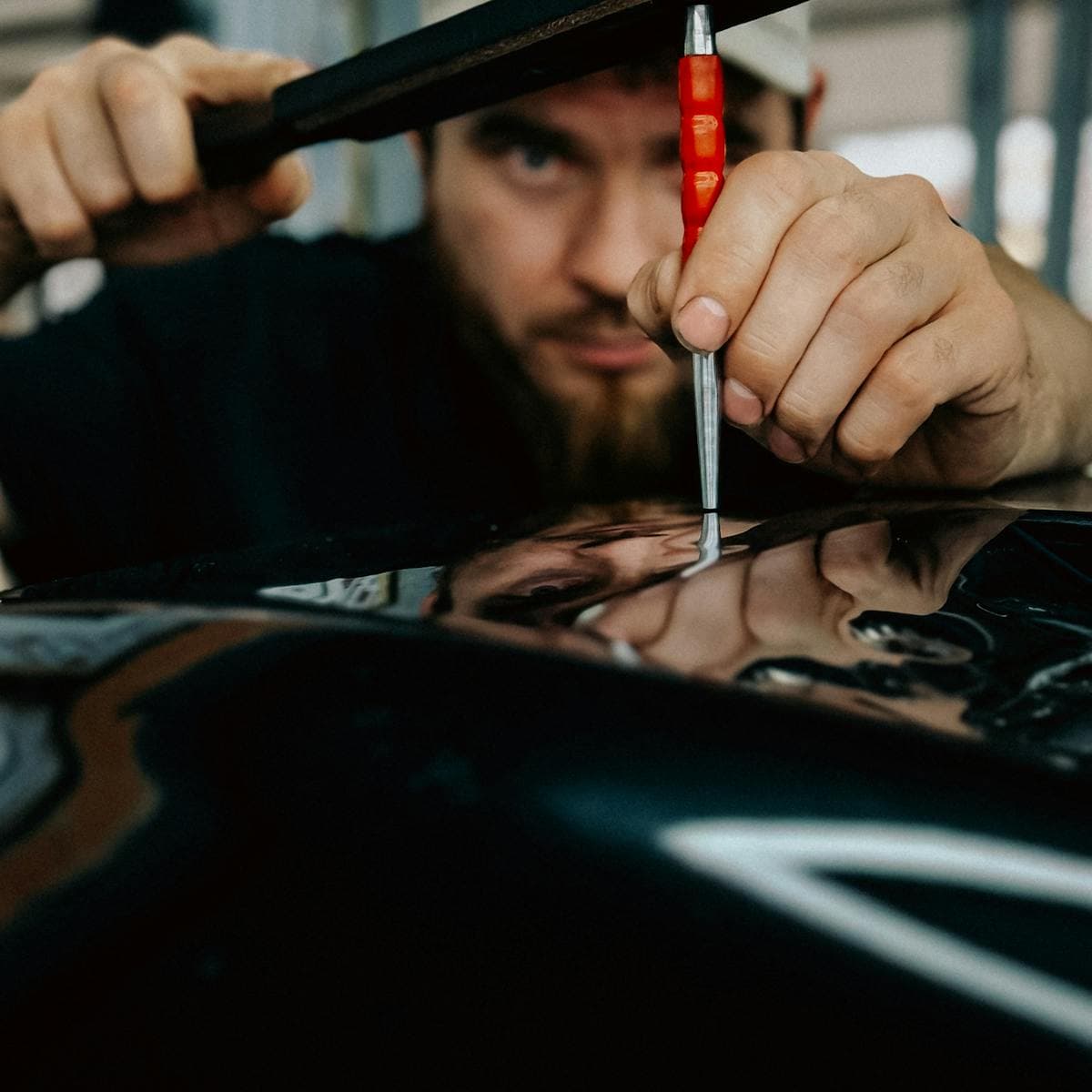 Close-up of precision dent repair work on a panel
