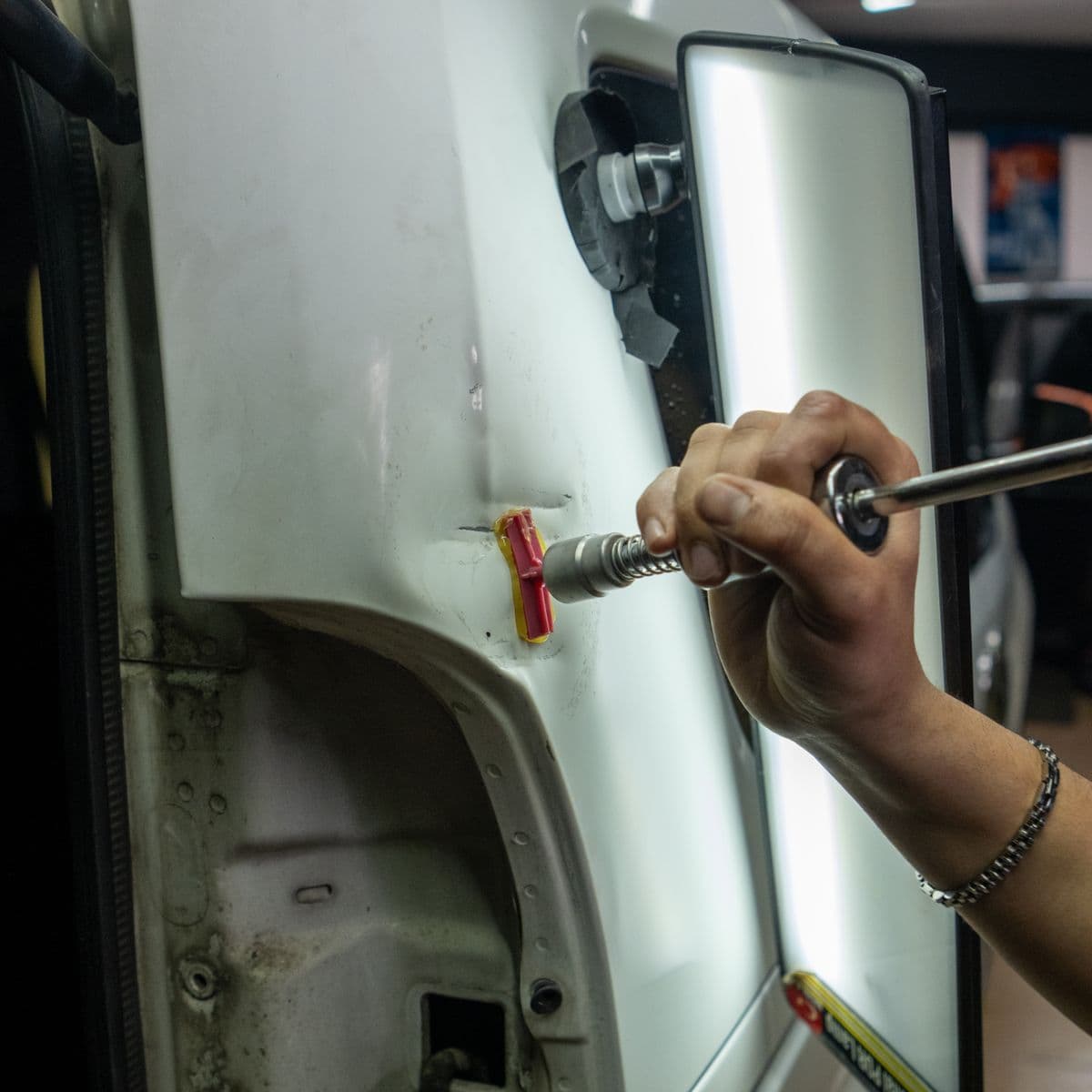Paintless dent repair using specialized tools